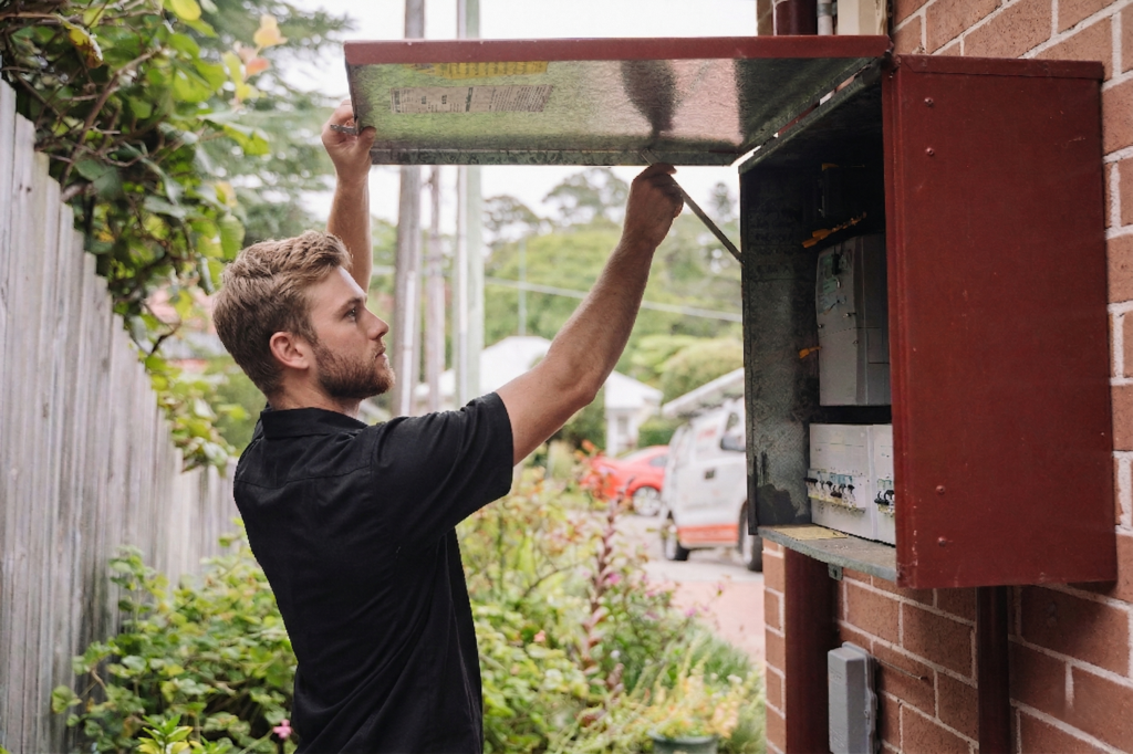 Electrician installing downlights in a Taren Point home